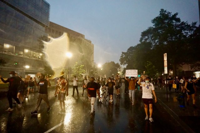 Black Lives Matter protesters marching through a downpour in Washington DC. 📷  Jaclyn Yost