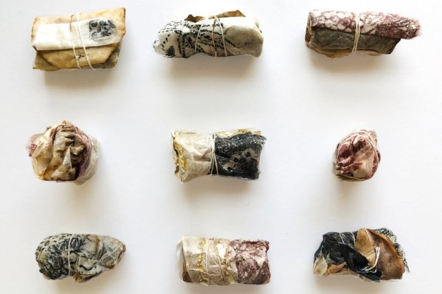 Source: Emily Jalinsky |Art Offerings: Fits on an Alter #1-#9&nbsp;    Teabag, collagraph print, gold leaf bundles.    Inside look at materials from Jalinsky: Teabags are from my daily use- I used the same ones that had dried that week. The prints were proofs from an online print course I offered. I treated them to give a translucency and pasted with the teabags intuitively while applying nori paste with my fingers letting the experience be very tactile for me. I wound the bundles with the teabag string so there wasn’t any added adhesive or bundling. Gold leaf was added at the end.